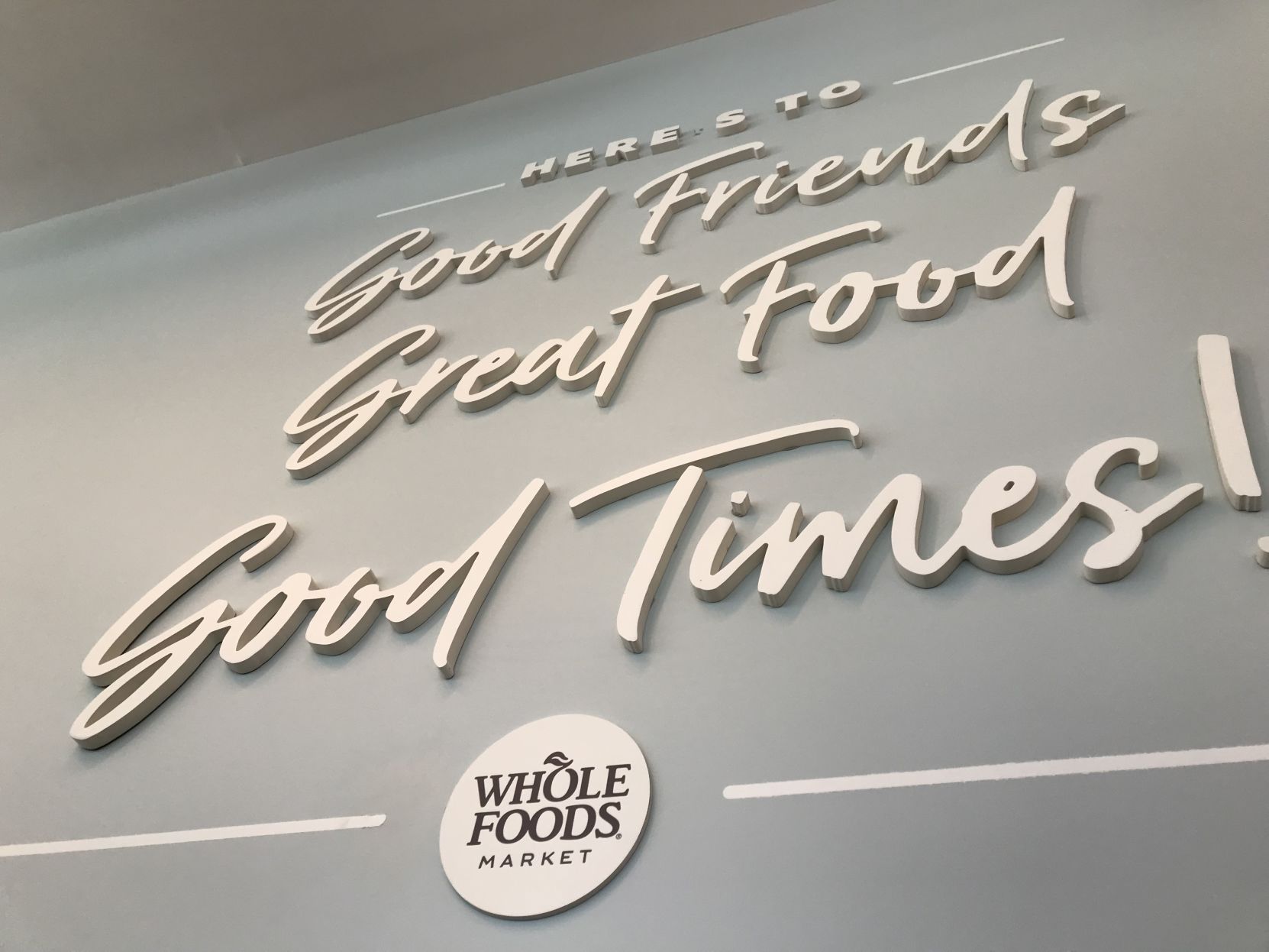 Whole Foods sign near restaurant seating area